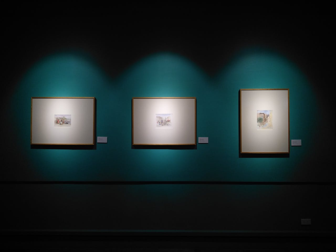 our-services-2 Framed artworks illuminated on a museum wall in Manila, capturing modern aesthetics.